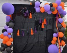 an outdoor area with balloons and tassels on it