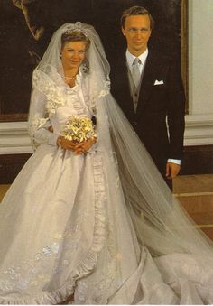 the bride and groom are posing for a photo