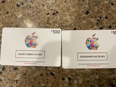 two apple credit cards sitting on top of a counter next to each other, both with different colored geometric designs