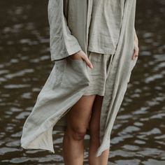 Our solid colored sleepwear collection is made from our heirloom linen blended with bamboo derived rayon for extra drape and softness. The Nola Robe is a mid length robe with loose ¾ length sleeves, a self tie, pockets, and an oversized fit. It’s the perfect lightweight piece to throw on over your pajamas, after a shower, or anytime you want to lounge. Long Summer Sleep Robe, Long Summer Robe For Sleep, Spring Solid Color Relaxed Fit Sleepwear, Solid Spring Sleepwear With Relaxed Fit, Comfortable Long Spring Sleepwear, Long Sleepwear For Spring Relaxation, Casual Oversized Robe For Loungewear, Summer Daywear Robe, Long Sleeve Linen Beach Robe