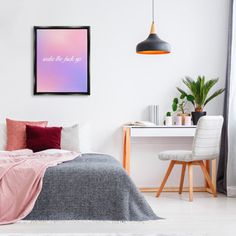 a bedroom with a bed, desk and chair next to a wall hanging above the bed