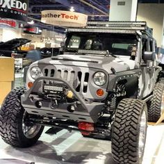 a jeep is on display at an auto show