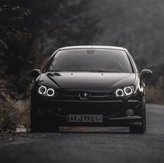 a black car parked on the side of a road