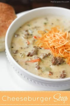 a white bowl filled with cheeseburger soup next to a baguette roll