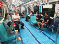 people are sitting on the subway train