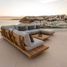 a wooden couch sitting on top of a patio