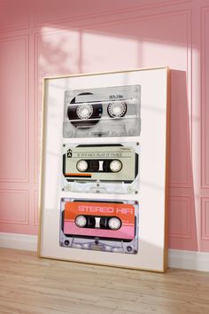 three cassette tapes stacked on top of each other in front of a pink wall