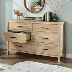 a wooden dresser with drawers and a mirror above it