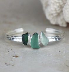 This handmade bracelet has been entirely handcrafted by myself in my home studio in Wales. The sea glass has been hand picked by myself on my favourite beach located in Penarth, Wales.  The sea glass has been set in a sterling silver setting. The cuff is roughly 6.5cm wide, 5.5cm tall and 1.6cm thick with a textured finish.  ------Instructions------ For a longer and better quality life for your handmade silver item, please avoid contact with chemicals similar to perfume, detergents and soaps.  - Penarth Wales, Sea Glass Jewelry Diy, Recycled Bracelets, Seaglass Jewelry, Sea Glass Bracelet, Sea Glass Pendant, Glass Projects, Glass Bracelet, Glass Texture