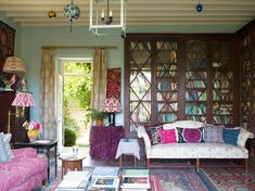 a living room filled with furniture and lots of bookshelves on top of it