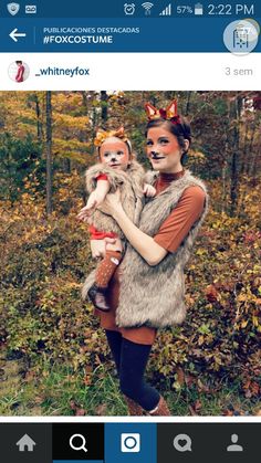 a woman is holding a small dog in her arms and wearing animal makeup on her face