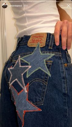 someone is showing off their jeans with stars painted on the bottom and back pockets