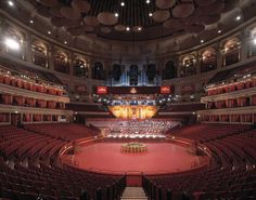 an auditorium with red carpet and rows of seats