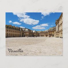 a square in the middle of an old european city with blue sky and white clouds