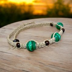 a close up of a bracelet on a wooden table