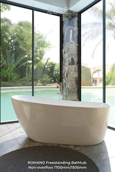 gloss white bathtub with elevated side in front of a glass wall that faces a bit swimming pool. Cubby Houses, Standing Bath, Wardrobe Furniture, Freestanding Bath, Freestanding Bathtub, Blue Space, Elegant Bathroom, Deck Chairs, Pool Accessories