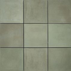 several square tiles arranged in rows on the floor, all different shades of grey and white