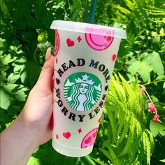 a hand holding up a starbucks cup in front of green plants and flowers with the words, head more for my baby on it