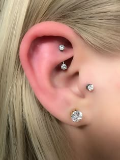 a blonde woman with three piercings on her ear