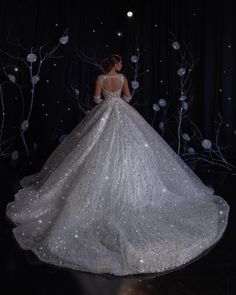 a woman in a white wedding dress standing on stage