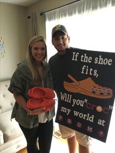 a man and woman standing next to each other in front of a shoe fit sign