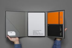 a person holding up an open book with different colors