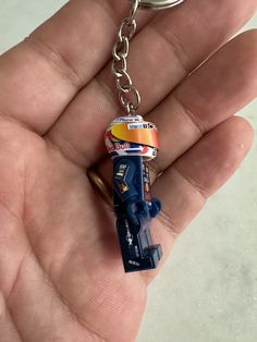 a person holding a key chain with a car on it