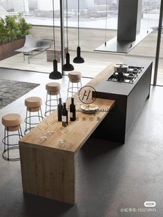 a modern kitchen with an island counter and stools in front of the stove top