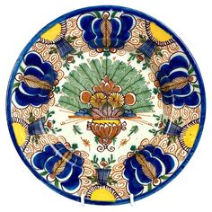 a decorative plate with blue flowers on it