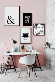 an image of a room with pink walls and white furniture in the corner, including a desk