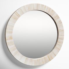 a round mirror hanging on the wall