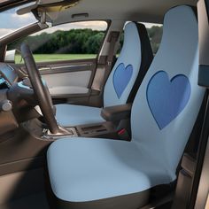 the interior of a car with two blue hearts on it's seat covers and steering wheel