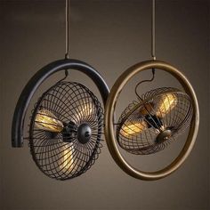 two lamps hanging from the ceiling with wire and lights on them, one light is turned on