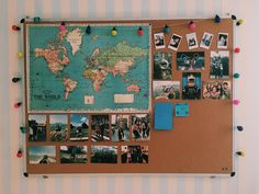 a bulletin board covered in pictures and magnets with pins attached to the corkboard