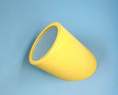 a yellow cup sitting on top of a blue table