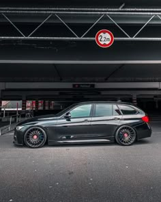 a black car parked in front of a parking garage