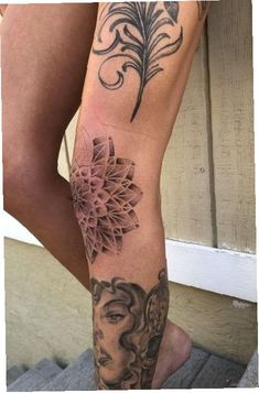 a woman's leg with tattoos on it and a flower in her left arm