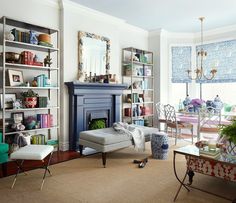 a living room filled with furniture and a fire place in the middle of a room