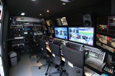 a control room with multiple monitors and other equipment