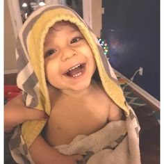 a little boy that is wearing a towel