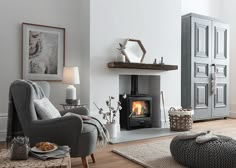 a living room filled with furniture and a fire place in the middle of the room