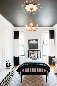 a black and white bedroom with a chandelier