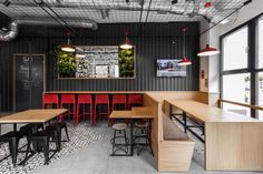 the interior of a restaurant with tables and stools