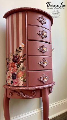 a pink dresser with flowers painted on it