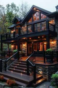 a very nice looking house with some lights on the porch and stairs leading up to it