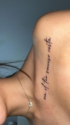 the back of a woman's neck with writing on it