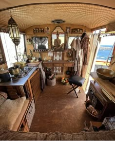 the inside of a camper with lots of furniture and decor on it's walls