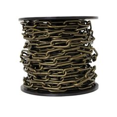 a spool of gold chain on a white background