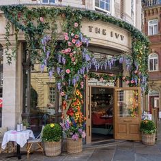 the ivy is growing on the side of the building and it's doors are open