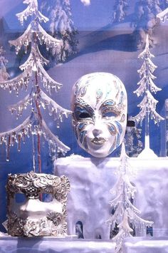 there is a white mask on display in front of a christmas tree and other decorations